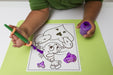 Child painting a picture of a cartoon character with an orange EaZyHold Grip Aid on a green mat.