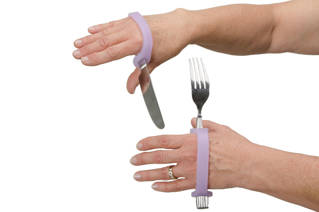 Person using a lavendar EaZyHold on a fork and knife against a white background