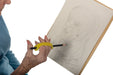 Person holding a pencil with an EaZyHold Grip Aid, drawing a portrait on a piece of paper