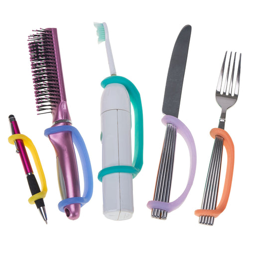 Set of tools including a hairbrush, toothbrush, knife, and fork with an EaZyHold Grip Aid on a white background
