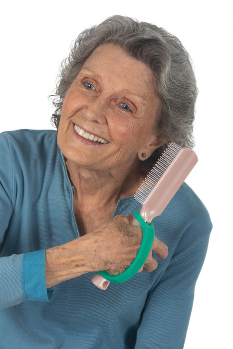 Woman combing her hair with an aqua EaZyHold Grid Aid on a white background