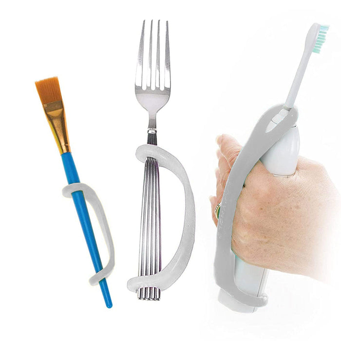 Fork, paintbrush, and toothbrush with EaZyHold Grip Aid on a white background