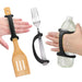 Hands holding a spatula, fork, and water bottle with a black EaZyHold Grid Aid on a white background