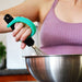 Person whisking ingredients in a bowl using an aqua EaZyHold Grid Aid 