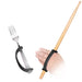 Hand holding a drum stick and a fork with a black EaZyHold Grid Aid on a white background