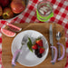 White plate with strawberries, blackberries, green beans, and a fork with a lavendar EaZyHold Grip Aid on a wooden surface
