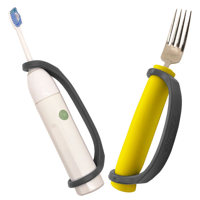 White electric toothbrush and yellow fork with a black EaZyHold Grip Aid on a white background