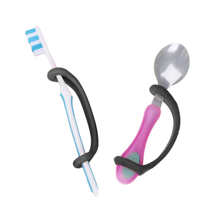 Set of toothbrush and spoon held with a black EaZyHold Grip Aid on a white background