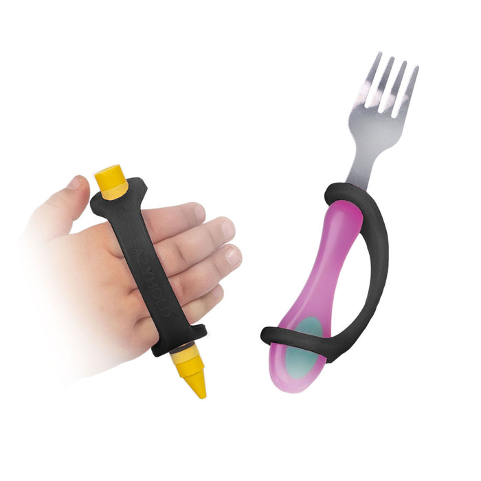 Yellow crayon and pink children's fork held with a black EaZyHold Grip Aid on a white background