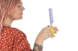Woman holding a comb with an EaZyHold Grip Aid against a white background