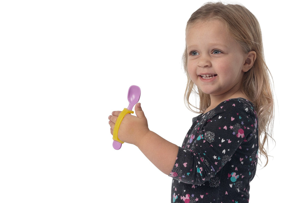 Child holding a purple spoon with a yellow EaZyHold Grip Aid on a white background