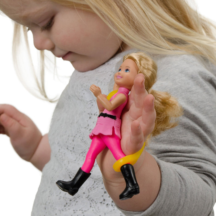 Child holding a small doll with an EaZyHold Grid Aid