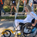 FreeWheel Wheelchair Attachment user bringing the torch to the 2024 Paralympic Games.