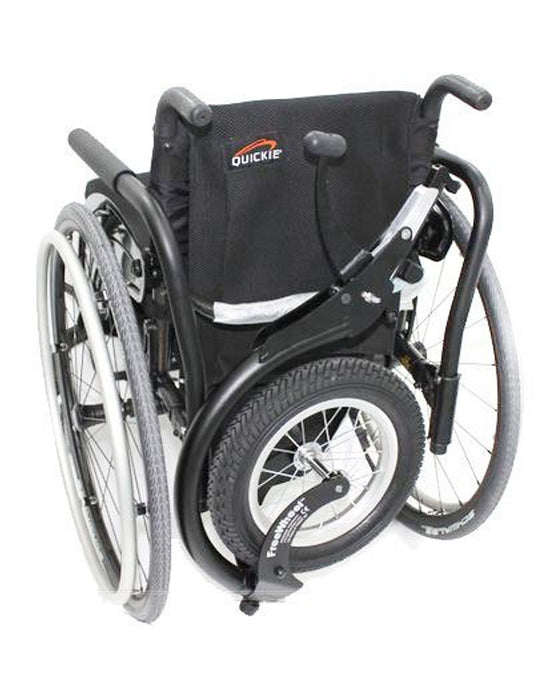 FreeWheel Wheelchair Attachment Black on the back of a wheelchair on a white background.