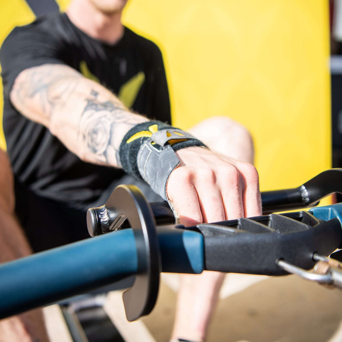 Detail of Equip Products Rowing Hook in use on a rowing machine by an athlete with an left above the elbow amputation.