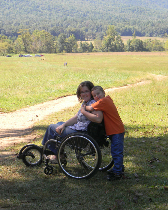 FreeWheel Wheelchair Attachment user with their son.