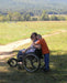 FreeWheel Wheelchair Attachment user with their son.