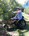FreeWheel Wheelchair Attachment user picking blueberries.