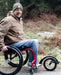 FreeWheel Wheelchair Attachment user in the woods.