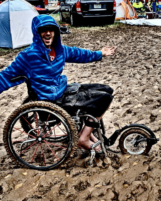FreeWheel Wheelchair Attachment user in the mud.