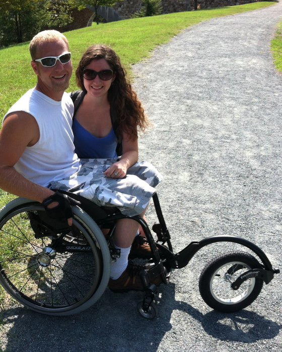 FreeWheel Wheelchair Attachment user with their partner.