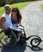 FreeWheel Wheelchair Attachment user with their partner.