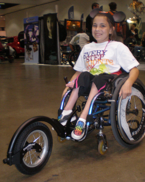 FreeWheel Wheelchair Attachment kid user with their device.