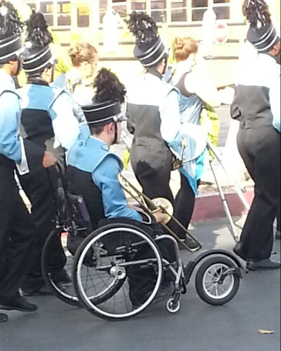 FreeWheel Wheelchair Attachment user in a marching band.