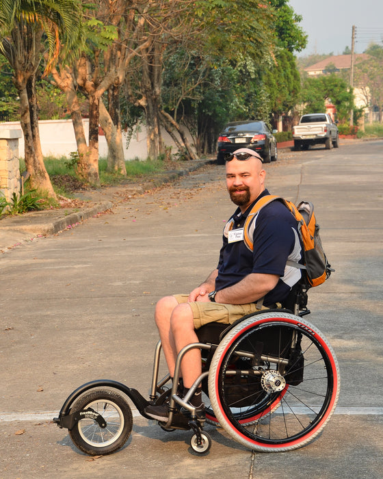 FreeWheel Wheelchair Attachment user in Thailand.