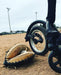 Detail of a FreeWheel Wheelchair Attachment Black on a wheelchair on a baseball field.