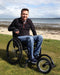 Potrait of a FreeWheel Wheelchair Attachment user picking blueberries.