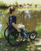 FreeWheel Wheelchair Attachment kid user along the water.