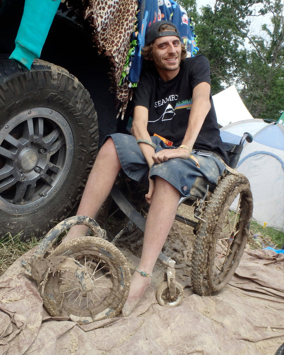 FreeWheel Wheelchair Attachment user with mud covering their device.
