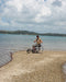 FreeWheel Wheelchair Attachment user on the beach.