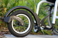 Detail of a FreeWheel Wheelchair Attachment Black on a wheelchair outdoors.
