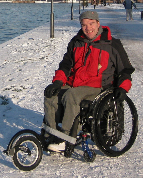 FreeWheel Wheelchair Attachment user in the snow.