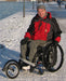 FreeWheel Wheelchair Attachment user in the snow.