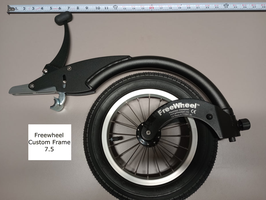 FreeWheel Wheelchair Attachment Black Size 7.5" against a tape measure.