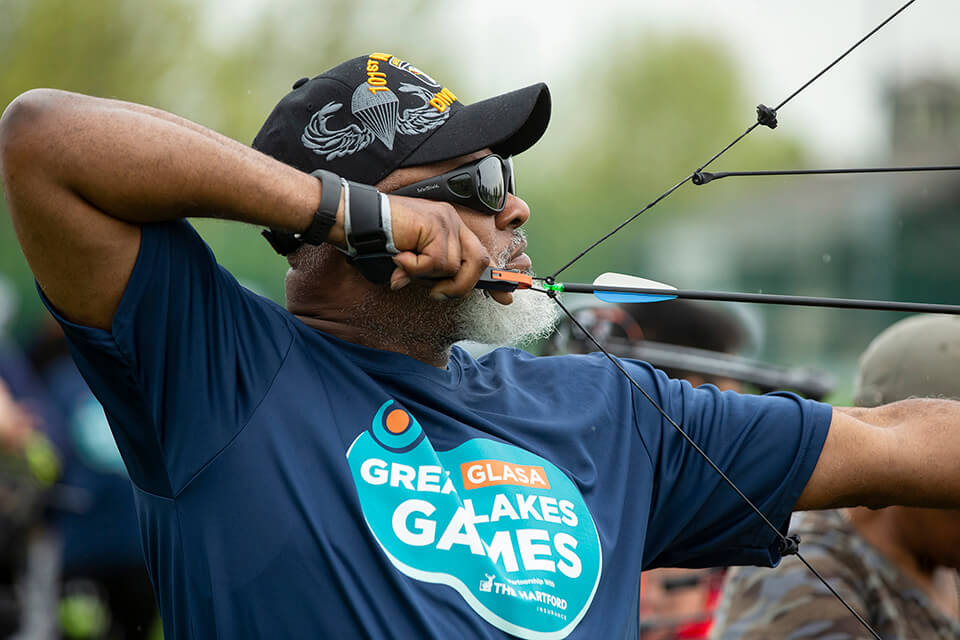 Athlete ready to release a bow in the archery competition at the Great Lakes Games.