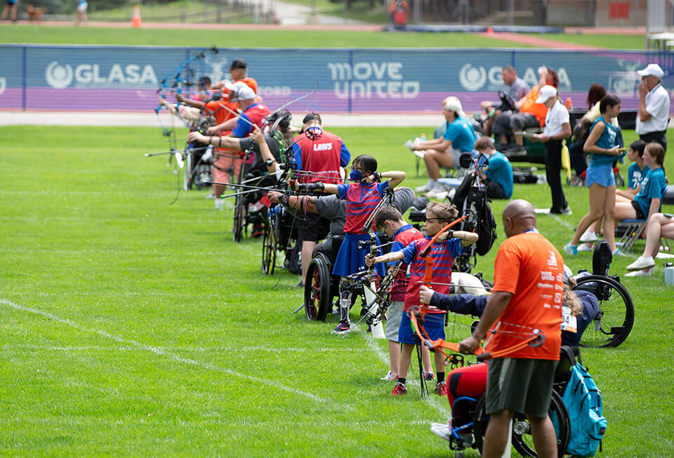 Rows of athletes competing in the archery competition at the Great Lakes Games.