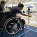 GLASA athletes using wheelchairs about to roll a boccia ball.