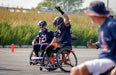 Chicago Bears Wheelchair Football celebrating with their hand raised.