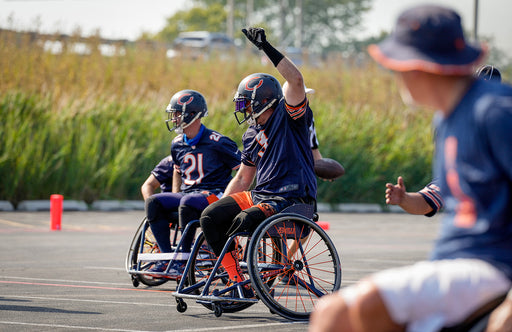 Chicago Bears Wheelchair Football celebrating with their hand raised.