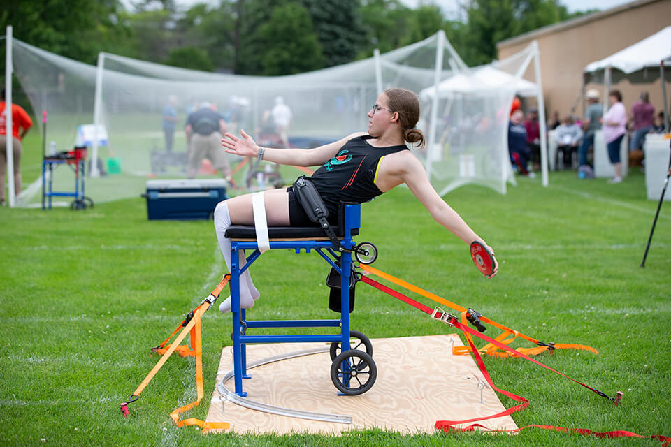 Athlete getting ready to throw discus from an elevated chair at the Great Lakes Games.