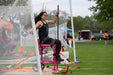 Athlete throwing discus from an elevated chair at the Great Lakes Games.