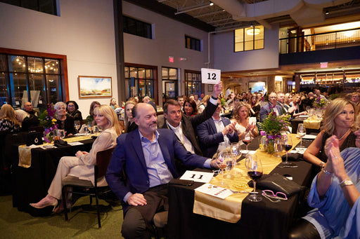 People sitting at tables in a large room with a high ceiling at the GLASA Gala