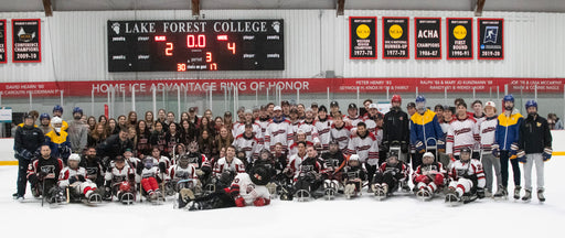 Group photo of glasa hockey players and staff on the Lake Forest College ice rink.