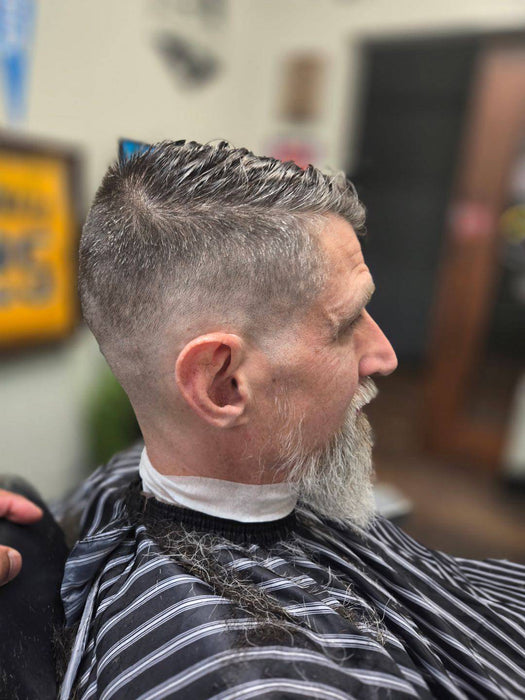 Man with a stylish haircut in a barbershop setting