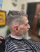 Man with a stylish haircut in a barbershop setting
