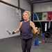 Equip Products Arm Cuff Jump Rope in use in the gym by an athlete with a left wrist amputation.